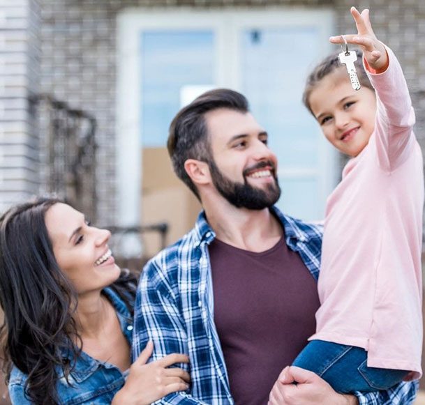 A family holding keys to their new home.