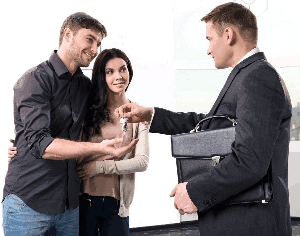 A man in suit handing keys to two women.