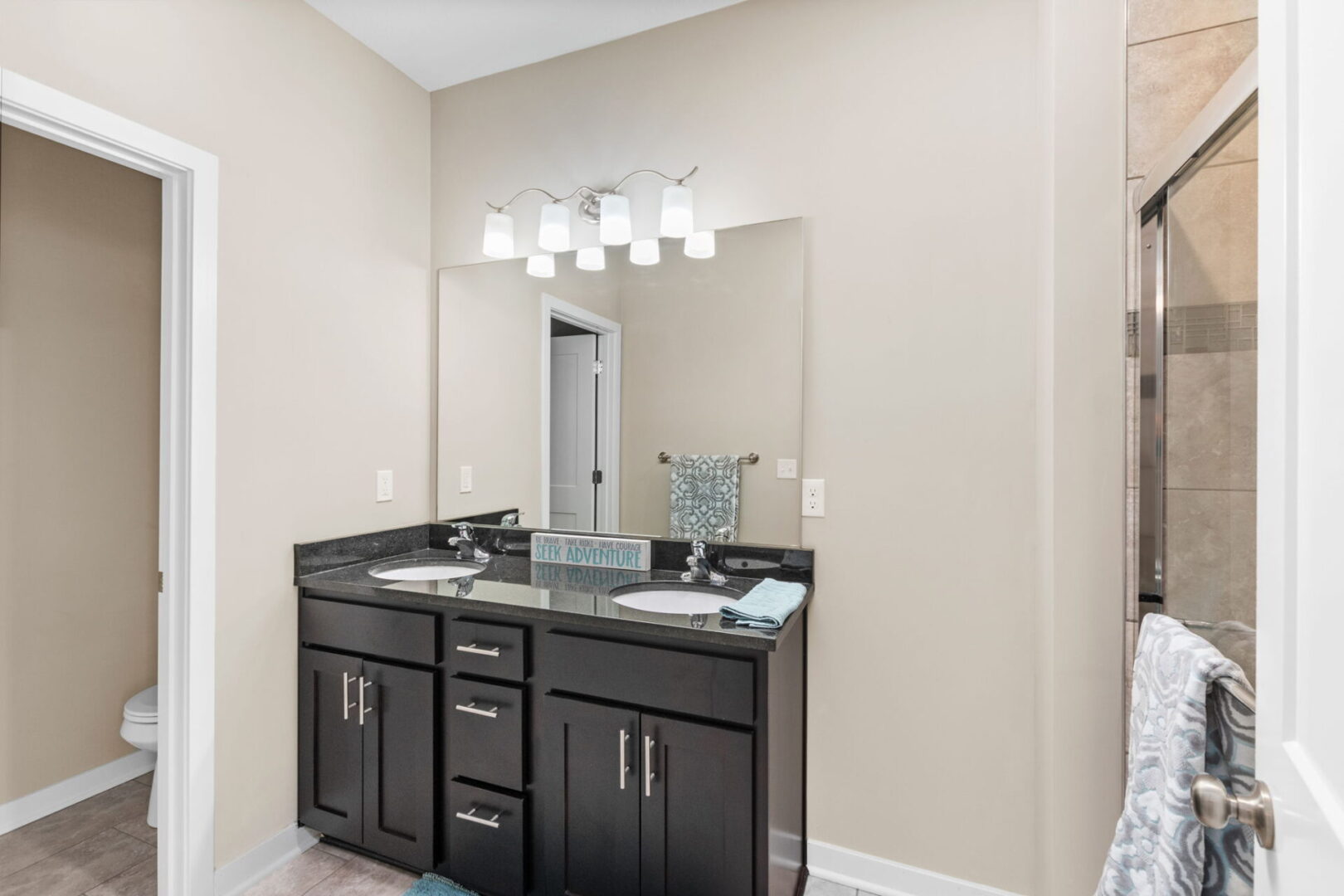 A bathroom with two sinks and a large mirror.