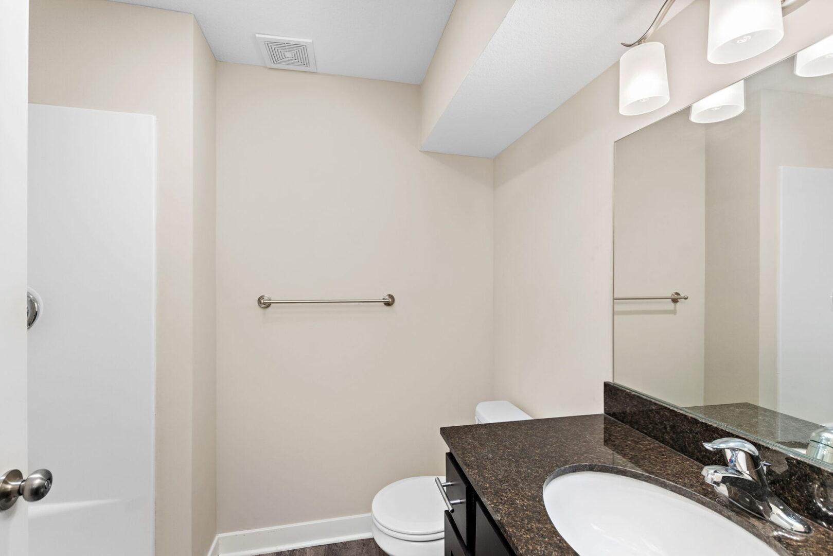 A bathroom with two sinks and a toilet.