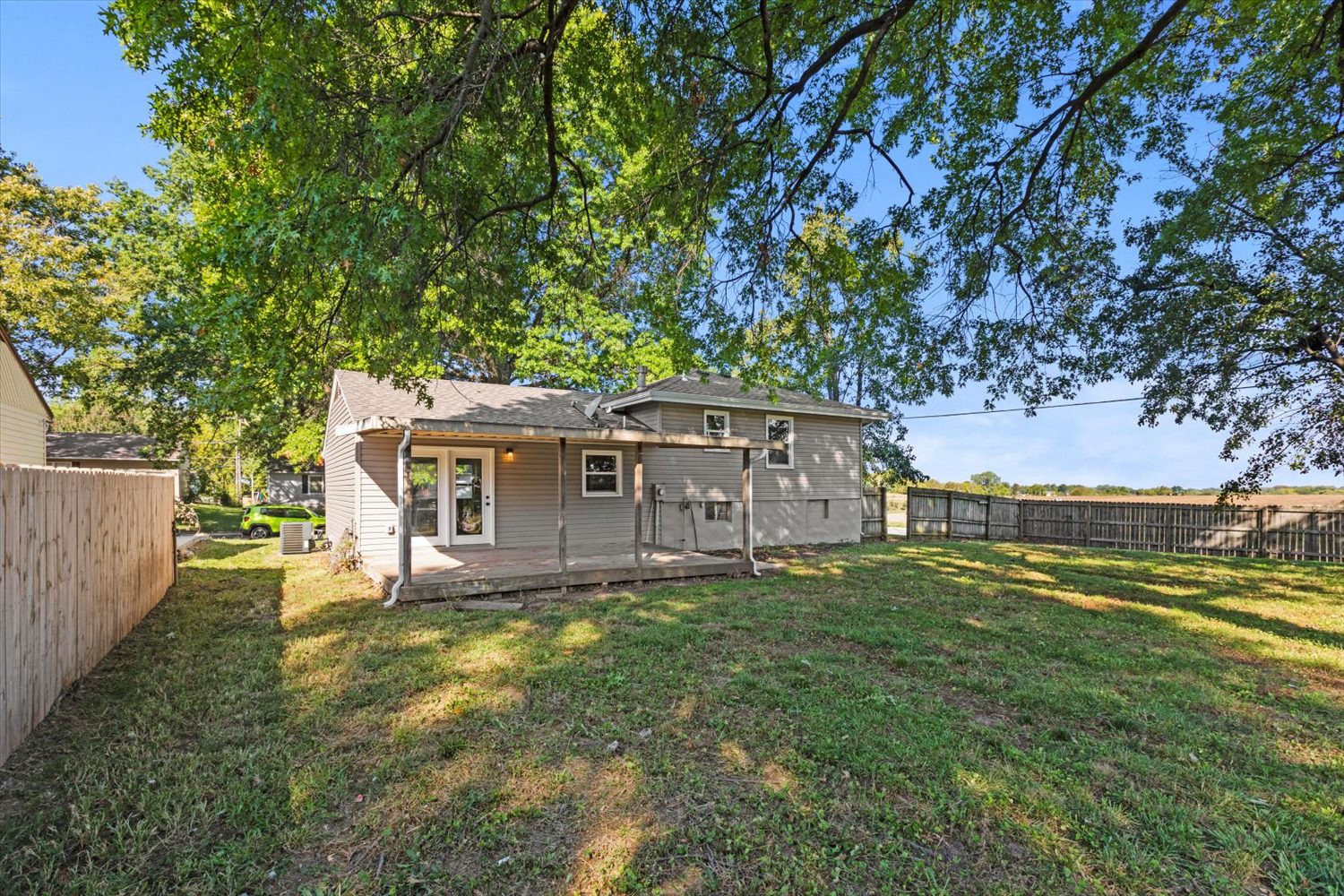 A house with grass and trees in the background.