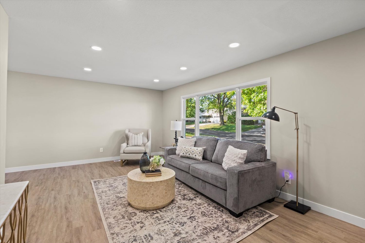 A living room with a couch, chair and table.