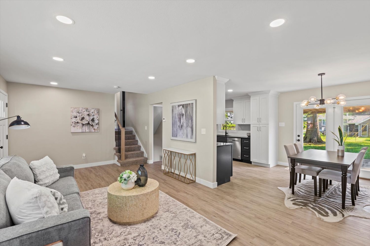 A living room with hard wood floors and white walls.